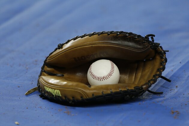 A catchers mitt is shown during batting practice before a baseball game between the Miami Marlins and the New York Yankees, Tuesday, June 16, 2015, in Miami. (AP Photo/Wilfredo Lee)