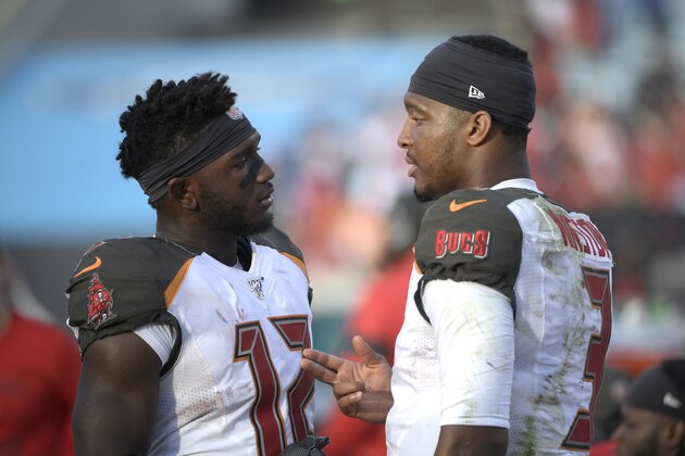 Tampa Bay Buccaneers quarterback Jameis Winston (3) talks with wide receiver Chris Godwin (12) on the sideline during the second half of an NFL football game against the Jacksonville Jaguars Sunday, Dec. 1, 2019, in Jacksonville, Fla. (AP Photo/Phelan M. Ebenhack)