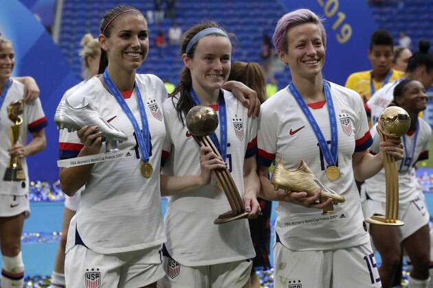 United States' Megan Rapinoe, right, United States' Alex Morgan, left, and United States' Rose Lavelle, center, pose with their trophies after the Women's World Cup final soccer match between US and The Netherlands at the Stade de Lyon in Decines, outside Lyon, France, Sunday, July 7, 2019. (AP Photo/Alessandra Tarantino)