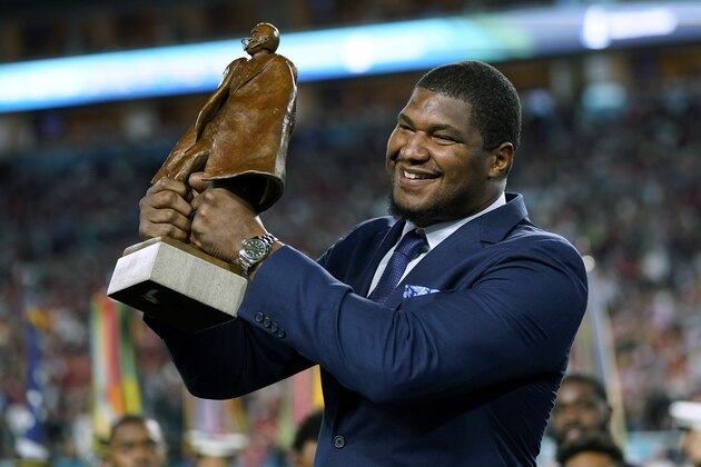 FILE - In this Sunday, Feb. 2, 2020, file photo, Jacksonville Jaguars' Calais Campbell raises the Walter Payton NFL Man of the Year trophy before the first half of the NFL Super Bowl 54 football game, in Miami Gardens, Fla. On Sunday, March 15, 2020, the Baltimore Ravens agreed to trade a fifth-round draft pick in the upcoming draft to the Jacksonville Jaguars for veteran defensive lineman Calais Campbell. (AP Photo/David J. Phillip, File) FILE - In this Sunday, Feb. 2, 2020, file photo, Jacksonville Jaguars' Calais Campbell raises the Walter Payton NFL Man of the Year trophy before the first half of the NFL Super Bowl 54 football game, in Miami Gardens, Fla. On Sunday, March 15, 2020, the Baltimore Ravens agreed to trade a fifth-round draft pick in the upcoming draft to the Jacksonville Jaguars for veteran defensive lineman Calais Campbell. (AP Photo/David J. Phillip, File)