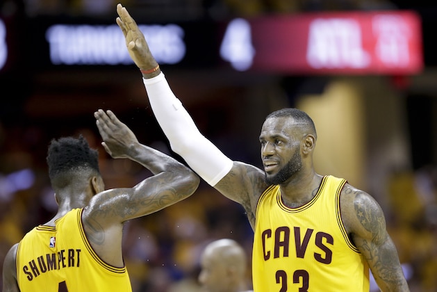 Cleveland Cavaliers forward LeBron James (23) high fives guard Iman Shumpert (4) during a timeout  in the first half of Game 4 of the NBA basketball Eastern Conference Finals against the Atlanta Hawks Tuesday, May 26, 2015, in Cleveland. (AP Photo/Tony Dejak)