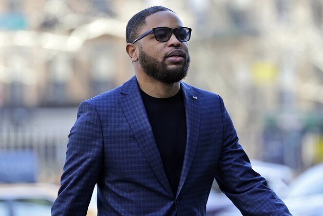 FILE - In this March 5, 2019, file photo, Christian Dawkins arrives at federal court in New York. A jury began deliberating on Monday, May 6, 2019, at the trial of Dawkins, a business manager, and youth basketball coach Merl Code, both accused of secretly bribing assistant college basketball coaches. (AP Photo/Seth Wenig, File)