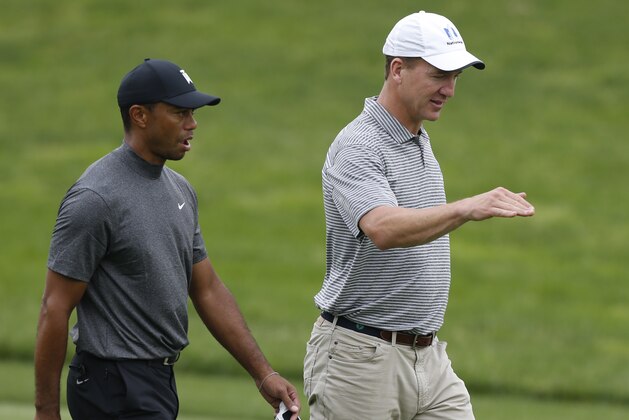 Former NFL player Peyton Manning, right, talks with Tiger Woods while playing in the pro-am round of the Memorial golf tournament Wednesday, May 29, 2019, in Dublin, Ohio. (Jay LaPrete/AP Images for NFL)