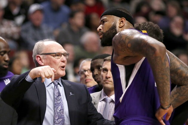 Sacramento Kings head coach George Karl, left, talks to DeMarcus Cousins during the second half of an NBA basketball game, Monday, March 21, 2016, in Chicago. The Bulls won 109-102. (AP Photo/Charles Rex Arbogast)