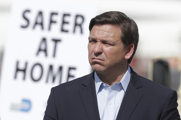 Florida Gov. Ron DeSantis listens during a news conference at a drive-through coronavirus testing site in front of Hard Rock Stadium, Monday, March 30, 2020, in Miami Gardens, Fla. Gov. Ron DeSantis doesn't want the people on the Holland America's Zandaam where four people died and others are sick to be treated in Florida, saying the state doesn't have the capacity to treat outsiders as the coronavirus outbreak spreads. (AP Photo/Wilfredo Lee)