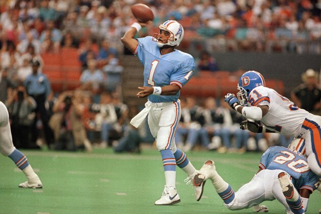 Houston Oilers quarterback Warren Moon (1) throws down field on Sunday, Oct. 7, 1991 in Houston against the Denver Broncos. Moon, who is apparently quarreling with management over incentive clauses in his contract, refused to talk with reporters after Sunday?s game. (AP Photo)