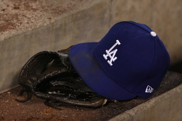 LOS ANGELES, CALIFORNIA - APRIL 26:  A detailed view of a Los Angeles Dodgers hat and catching glove is seen on the dugout steps during the sixth inning of the MLB game between the Pittsburgh Pirates and the Los Angeles Dodgers at Dodger Stadium on April 26, 2019 in Los Angeles, California. The Dodgers defeated the Pirates 6-2. (Photo by Victor Decolongon/Getty Images)