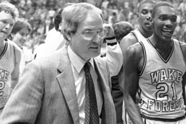 FILE - In this March 24, 1984, file photo, Wake Forest coach Carl Tacy, left, leaves the court with members of his team following their 73-71 victory over DePaul in the semifinals of the NCAA Midwest Regional in St. Louis, Mo. ASt right is Wake Forest's Kenny Green (21). Former Wake Forest and Marshall basketball coach Carl Tacy has died at 87. Tacy's son, Carl Jr., told The Associated Press his father died early Thursday, April 2, 2020. (AP Photo/File)
