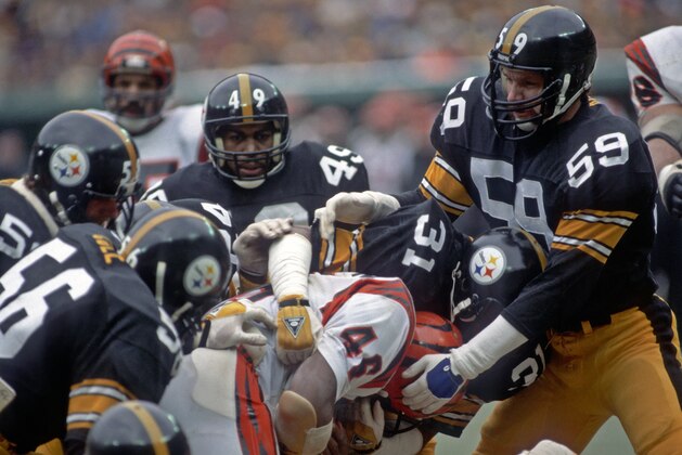 PITTSBURGH, PA - DECEMBER 13:  Safety Donnie Shell #31 and linebacker Jack Ham #59 of the Pittsburgh Steelers tackle running back Pete Johnson #46 of the Cincinnati Bengals with assistance from linebackers Robin Cole #56 and Jack Lambert #58 and cornerback Dwayne Woodruff #49 during a game at Three Rivers Stadium on December 13, 1981 in Pittsburgh, Pennsylvania.  The Bengals defeated the Steelers 17-10.  (Photo by George Gojkovich/Getty Images)