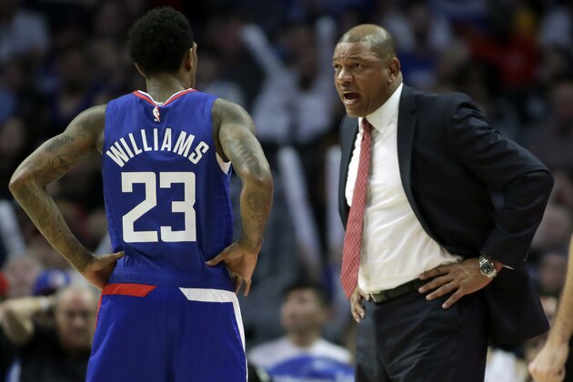 Los Angeles Clippers head coach Doc Rivers, right, talks to Los Angeles Clippers guard Lou Williams during the second half of an NBA basketball game against the Minnesota Timberwolves in Los Angeles, Saturday, Feb. 1, 2020. (AP Photo/Alex Gallardo)