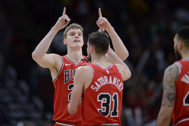 Chicago Bulls' Lauri Markkanen (24) celebrates with teammate Tomas Satoransky (31) during the second half of the team's NBA basketball game against the Cleveland Cavaliers on Tuesday, March 10, 2020, in Chicago. (AP Photo/Paul Beaty)