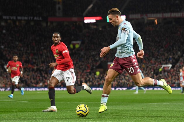 MANCHESTER, ENGLAND - DECEMBER 01: Jack Grealish of Aston Villa controls the ball as Aaron Wan-Bissaka of Manchester United looks on during the Premier League match between Manchester United and Aston Villa at Old Trafford on December 01, 2019 in Manchester, United Kingdom. (Photo by Stu Forster/Getty Images)
