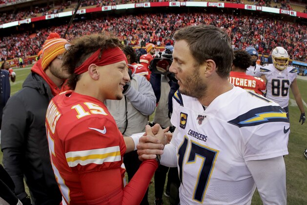 Kansas City Chiefs quarterback Patrick Mahomes (15) and Los Angeles Chargers quarterback Philip Rivers (17) talk after an NFL football game Sunday, Dec. 29, 2019, in Kansas City, Mo. (AP Photo/Charlie Riedel)