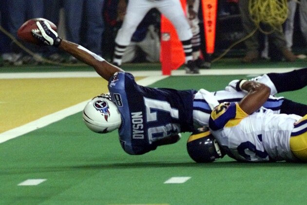 Tennessee Titans wide receiver Kevin Dyson (87) tries but fails to get the ball into the end zone as he is tackled by St. Louis Rams' Mike Jones on the final play of Super Bowl XXXIV on Sunday, Jan. 30, 2000, in Atlanta. The Rams won 23-16. (AP Photo/John Gaps III)