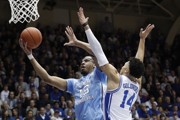 North Carolina forward Garrison Brooks (15) drives to the basket whiule Duke guard Jordan Goldwire (14) defends during the first half of an NCAA college basketball game in Durham, N.C., Saturday, March 7, 2020. (AP Photo/Gerry Broome)