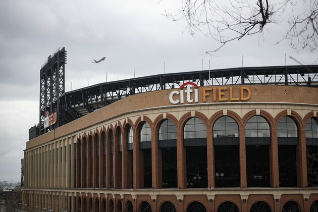 Parking lots sit empty surrounding Citifield, the home of the New York Mets, Wednesday, March 25, 2020, in the Queens borough of New York. Gov. Andrew Cuomo sounded his most dire warning yet about the coronavirus pandemic Tuesday, saying the infection rate in New York is accelerating and the state could be as close as two weeks away from a crisis that sees 40,000 people in intensive care. Such a surge would overwhelm hospitals, which now have just 3,000 intensive care unit beds statewide. (AP Photo/John Minchillo)