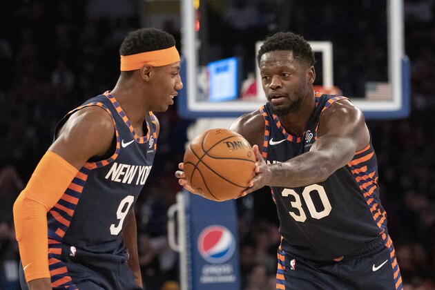 New York Knicks forward Julius Randle (30) playfully hands the ball off to New York Knicks guard RJ Barrett (9) in the closing moments of an NBA basketball game against the Chicago Bulls, Saturday, Feb. 29, 2020 in New York. The Knicks won 125-115. (AP Photo/Mark Lennihan)