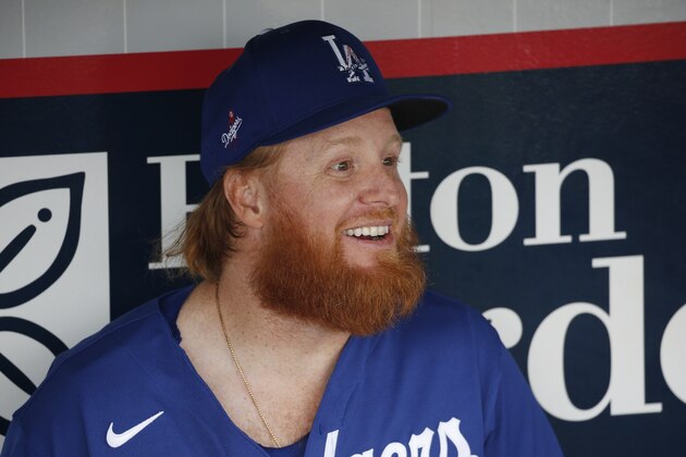 Los Angeles Dodgers' Justin Turner smiles as he talks with teammates prior to a spring training baseball game against the Cincinnati Reds Monday, March 2, 2020, in Goodyear, Ariz. (AP Photo/Ross D. Franklin)