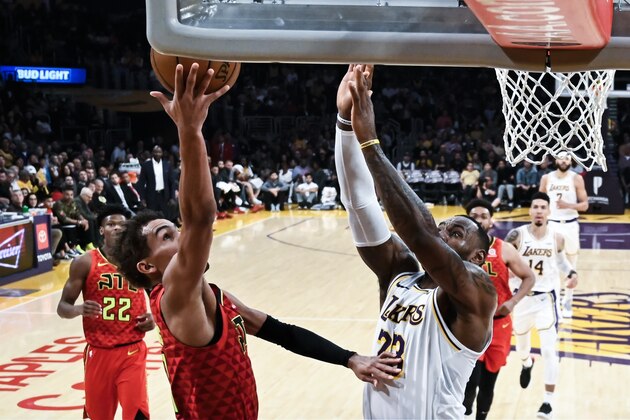 Atlanta Hawks's Trae Young (11) goes uo to basket against Los Angeles Lakers' LeBron James (23) during the second half of an NBA basketball game, Sunday, Nov. 17, 2019, in Los Angeles. The Lakers won 122-101. (AP Photo/Ringo H.W. Chiu)
