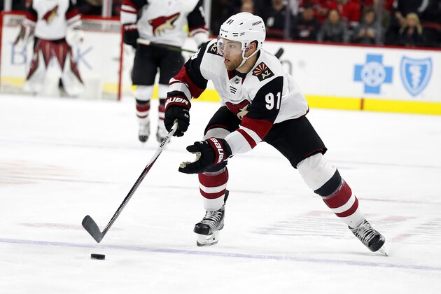 Arizona Coyotes' Taylor Hall (91) moves the puck against the Carolina Hurricanes during the second period of an NHL hockey game in Raleigh, N.C., Friday, Jan. 10, 2020. (AP Photo/Karl B DeBlaker) Arizona Coyotes' Taylor Hall (91) moves the puck against the Carolina Hurricanes during the second period of an NHL hockey game in Raleigh, N.C., Friday, Jan. 10, 2020. (AP Photo/Karl B DeBlaker)