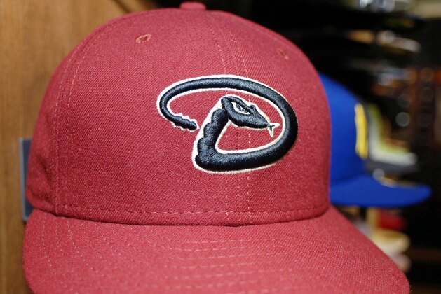 A New Era Cap Co. 59 FIFTY Authentic Collection On Field Cap with the updated Arizona Diamondbacks logo sits on a display stand at the company's headquarters in Buffalo, N.Y., as seen here on Tuesday, Feb. 20, 2007. The new MLB caps are made of a polysynthetic fabric to aid in wick management for the players. (AP Photo/Don Heupel)