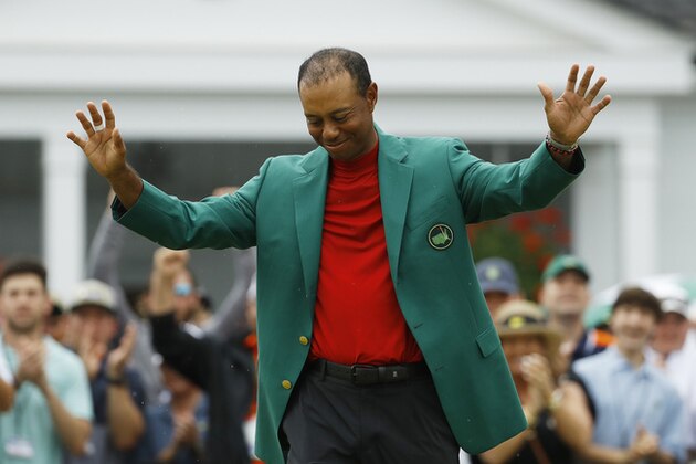 FILE - In this April 14, 2019, file photo, Tiger Woods smiles as he wears his green jacket after winning the Masters golf tournament in Augusta, Ga. Fourteen years after his last Masters win and 11 years after his last major, after fighting through chronic back problems, multiple surgeries, a bout with painkillers and long after just about everybody had written him off, Woods claimed his fifth green jacket. (AP Photo/Matt Slocum, File) FILE - In this April 14, 2019, file photo, Tiger Woods smiles as he wears his green jacket after winning the Masters golf tournament in Augusta, Ga. Fourteen years after his last Masters win and 11 years after his last major, after fighting through chronic back problems, multiple surgeries, a bout with painkillers and long after just about everybody had written him off, Woods claimed his fifth green jacket. (AP Photo/Matt Slocum, File)