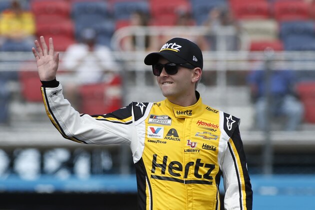 William Byron waves to fans during driver introductions prior to the NASCAR Cup Series auto race at Phoenix Raceway, Sunday, March 8, 2020, in Avondale, Ariz. (AP Photo/Ralph Freso)