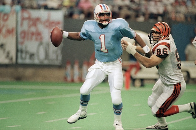 Houston Oiler quarterback Warren Moon (1) is pressured by Cincinnati Bengal Natu Tautagaloa (96) as he gets a pass off in the third quarter on Sunday, Oct. 15, 1990 in Houston. The Oilers beat the Bengals 48 to 17. (AP Photo/David Scarbrough) Houston Oiler quarterback Warren Moon (1) is pressured by Cincinnati Bengal Natu Tautagaloa (96) as he gets a pass off in the third quarter on Sunday, Oct. 15, 1990 in Houston. The Oilers beat the Bengals 48 to 17. (AP Photo/David Scarbrough)