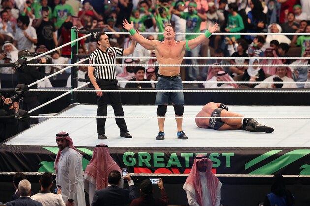 John Cena (C) celebrates defeating Triple H (R) during the World Wrestling Entertainment (WWE) Greatest Royal Rumble event in the Saudi coastal city of Jeddah on April 27, 2018. (Photo by STRINGER / AFP)        (Photo credit should read STRINGER/AFP via Getty Images)