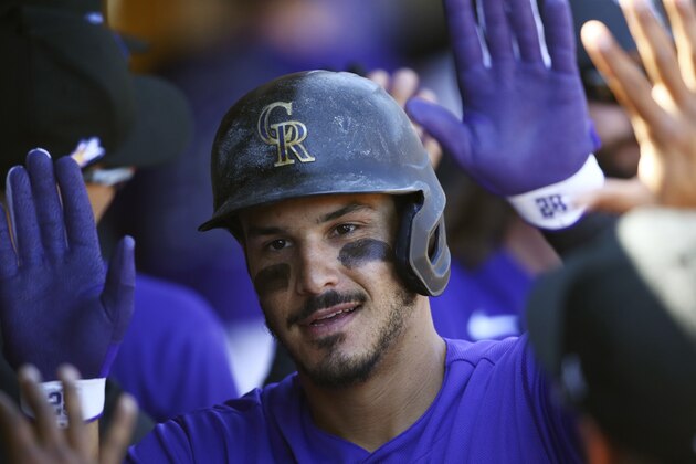 Colorado Rockies' Nolan Arenado celebrates his two-run home run against the Chicago Cubs during the first inning of a spring training baseball game Tuesday, March 3, 2020, in Scottsdale, Ariz. The Rockies defeated the Cubs 11-10. (AP Photo/Ross D. Franklin)
