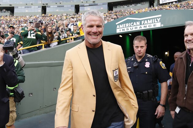 Former Green Bay Packers' Brett Favre smiles as he arrives for a halftime ceremony  of an NFL football game against the Dallas Cowboys Sunday, Oct. 16, 2016, in Green Bay, Wis. (AP Photo/Matt Ludtke)