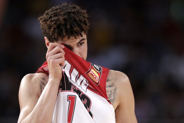 LaMelo Ball of the Illawarra Hawks wipes his face during their game against the Sydney Kings in the Australian Basketball League in Sydney, Sunday, Nov. 17, 2019. (AP Photo/Rick Rycroft)