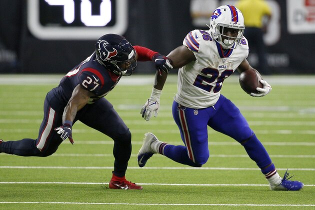 HOUSTON, TEXAS - JANUARY 04: Running back Devin Singletary #26 of the Buffalo Bills carries the ball against  Mike Adams #27 of the Houston Texans during  the AFC Wild Card Playoff game at NRG Stadium on January 04, 2020 in Houston, Texas. (Photo by Bob Levey/Getty Images)