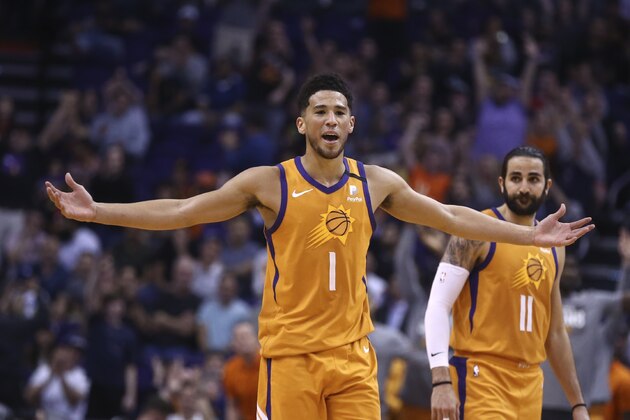 Phoenix Suns guard Devin Booker (1) celebrates a 3-pointer against the Portland Trail Blazers by Suns' Aron Baynes, near guard Ricky Rubio (11) during the second half of an NBA basketball game Friday, March 6, 2020, in Phoenix. (AP Photo/Ross D. Franklin)