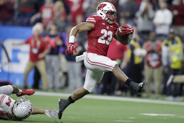FILE - In this Dec. 7, 2019, file photo, Wisconsin running back Jonathan Taylor (23) runs for a touchdown past Ohio State cornerback Shaun Wade (24) during the first half of the Big Ten championship NCAA college football game, in Indianapolis. Taylor was selected to The Associated Press All-Big Ten Conference team, Wednesday, Dec. 11, 2019. (AP Photo/Michael Conroy, File)