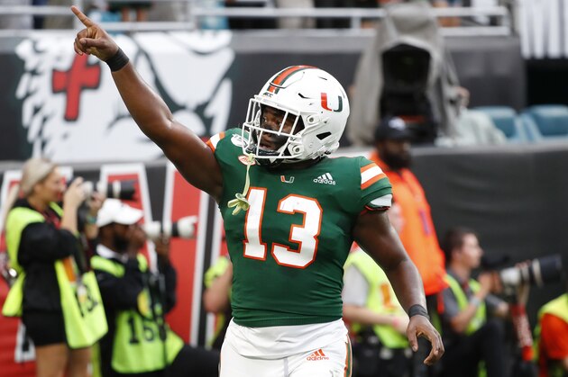 Miami running back DeeJay Dallas (13) celebrates a touch down during the first half of an NCAA college football game against Louisville, Saturday, Nov. 9, 2019, in Miami Gardens, Fla. (AP Photo/Wilfredo Lee)