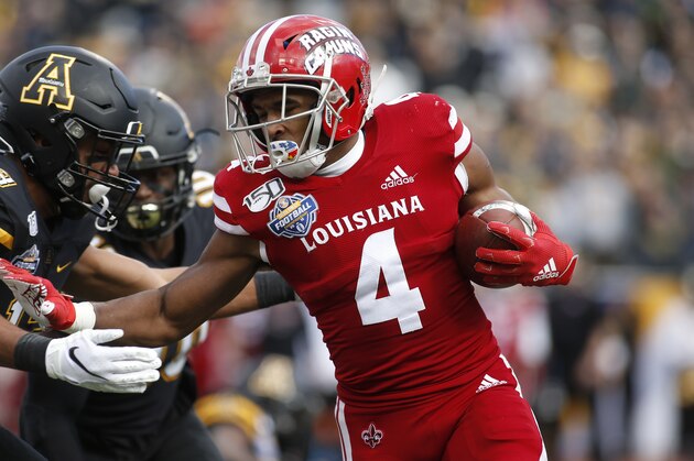 Louisiana-Lafayette running back Raymond Calais (4) fends off Appalachian State defensive back Kaiden Smith (13) during the first half of an NCAA college football game in the Sun Belt Football Championship on Saturday, Dec. 7, 2019, in Boone, N.C. (AP Photo/Brian Blanco)