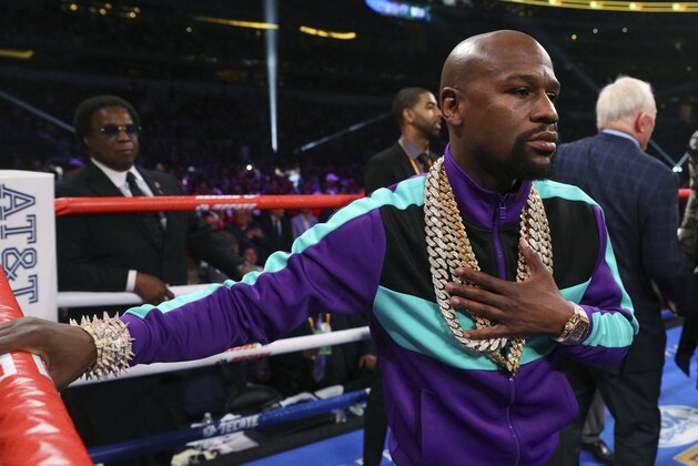 Floyd Mayweather stands in the ring before the IBF welterweight championship bout between Errol Spence Jr. and Mikey Garcia on Saturday, March 16, 2019, in Arlington, Texas. (AP Photo/Richard W. Rodriguez) Floyd Mayweather stands in the ring before the IBF welterweight championship bout between Errol Spence Jr. and Mikey Garcia on Saturday, March 16, 2019, in Arlington, Texas. (AP Photo/Richard W. Rodriguez)