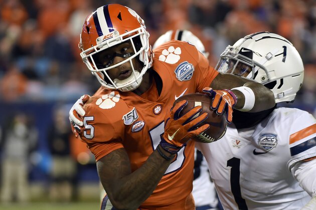 FILE - In this Dec. 7, 2019, file photo, Clemson wide receiver Tee Higgins (5) catches a pass while Virginia cornerback Nick Grant (1) defends during the second half of the Atlantic Coast Conference championship NCAA college football game in Charlotte, N.C. The NFL's shutdown because of the coronavirus pandemic is denying teams the opportunity to get face time with draft prospects who have been injured, have checkered pasts or are under the radar. Higginsâ€™ 6-foot-4 frame and superb hands stand out in a deep pool of receivers. Speed is the question, and a private workout might have helped. (AP Photo/Mike McCarn, File)