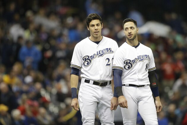 Milwaukee Brewers' Christian Yelich talks with Ryan Braun during the fourth inning of a baseball game against the Washington Nationals Wednesday, May 8, 2019, in Milwaukee. (AP Photo/Aaron Gash)