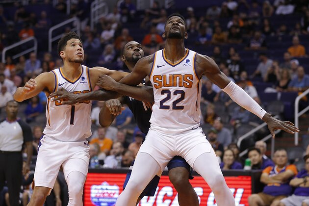 Phoenix Suns center Deandre Ayton (22) and Devin Booker (1) in the first half during a preseason NBA basketball game against the Minnesota Timberwolves, Tuesday, Oct. 8, 2019, in Phoenix. (AP Photo/Rick Scuteri)