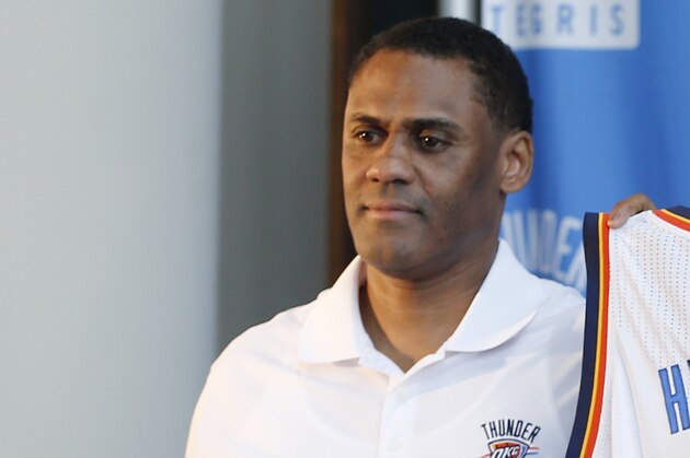 Oklahoma City Thunder forward Josh Huestis, right, and Troy Weaver, left, Thunder vice president and assistant general manager, hold a basketball jersey as Huestis is introduced during a news conference in Oklahoma City, Friday, June 27, 2014. (AP Photo/Sue Ogrocki)