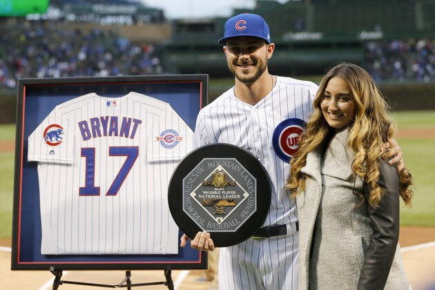 Chicago Cubs' Kris Bryant, left, poses with his wife Jessica after Bryant received his National League MVP award before a baseball game between the Cubs and Philadelphia Phillies Tuesday, May 2, 2017, in Chicago. (AP Photo/Charles Rex Arbogast)