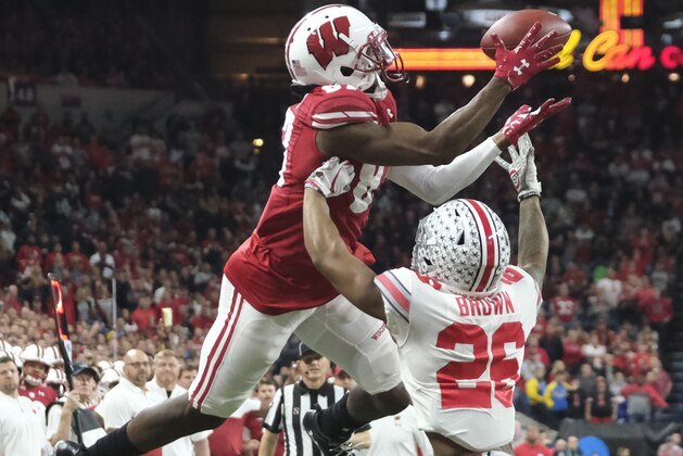 Wisconsin wide receiver Quintez Cephus (87) makes a catch over Ohio State cornerback Cameron Brown (26) during the first half of the Big Ten championship NCAA college football game Saturday, Dec. 7, 2019, in Indianapolis. (AP Photo/AJ Mast)