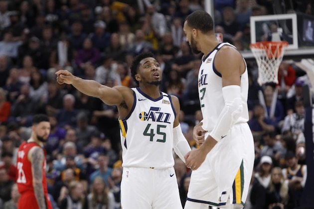 Utah Jazz's Donovan Mitchell (45) and Rudy Gobert talk during a time out in the second half during an NBA basketball game against the Houston Rockets on Saturday, Feb. 22, 2020, in Salt Lake City. The Houston Rockets defeated the Utah Jazz 120-110. (AP Photo/Kim Raff)
