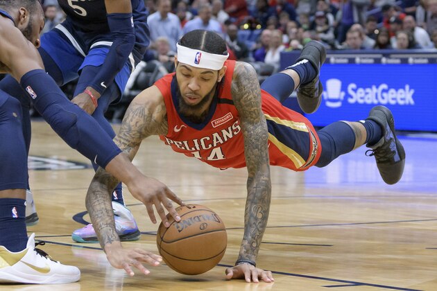 New Orleans Pelicans forward Brandon Ingram (14) dives for a loose ball against Minnesota Timberwolves guard Josh Okogie (20) next to guard Malik Beasley (5) in the second half of an NBA basketball game in New Orleans, Tuesday, March 3, 2020. (AP Photo/Matthew Hinton)