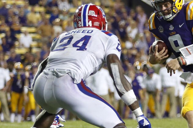 LSU quarterback Joe Burrow (9) runs the ball in front of Louisiana Tech cornerback L'Jarius Sneed (24) in the second half of an NCAA college football game in Baton Rouge, La., Saturday, Sept. 22, 2018. LSU won 38-21. (AP Photo/Tyler Kaufman)