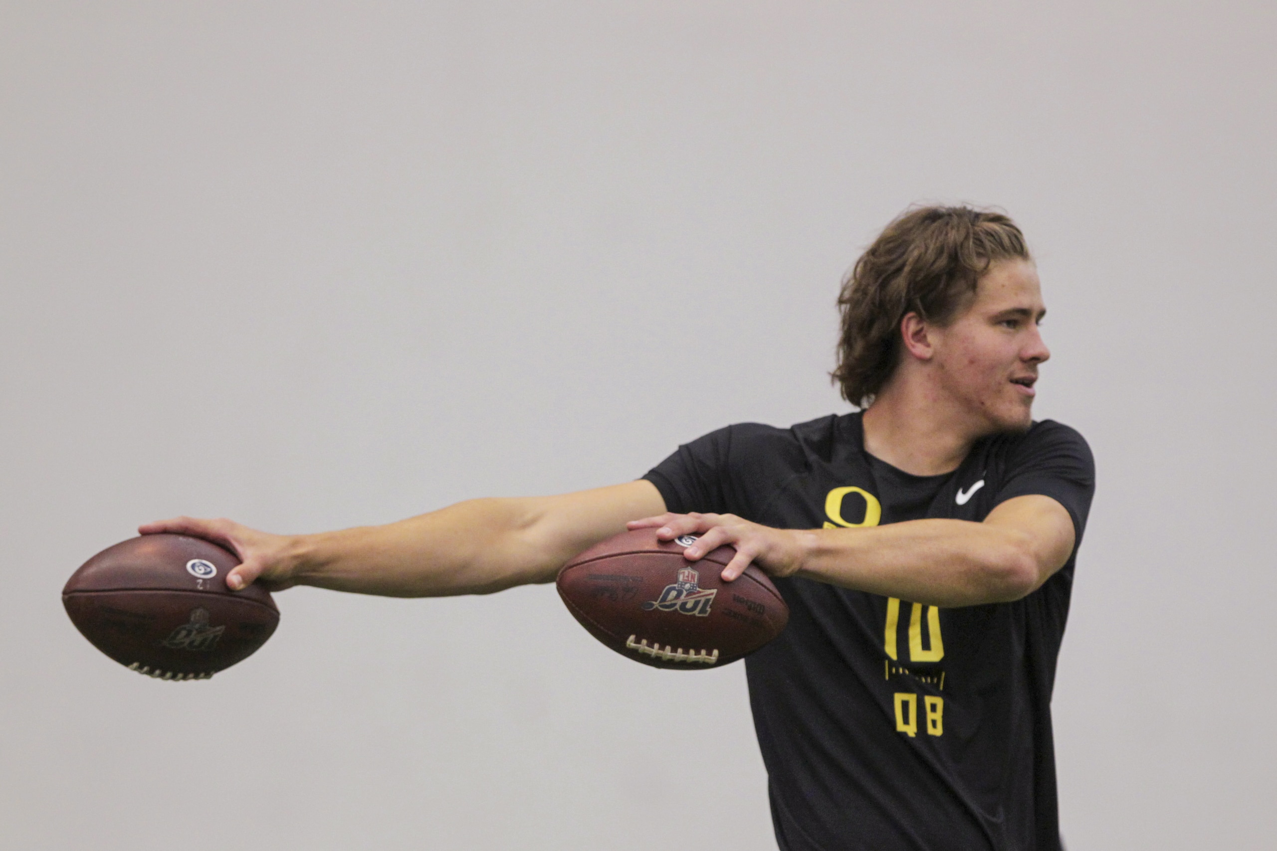 Quarterback Justin Herbert works out during Oregon's football pro day in Eugene, Ore., Thursday, March 12, 2020. (AP Photo/Collin Andrew)