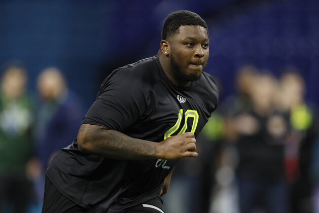 Michigan offensive lineman Cesar Ruiz runs a drill at the NFL football scouting combine in Indianapolis, Friday, Feb. 28, 2020. (AP Photo/Charlie Neibergall)