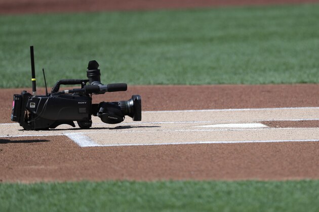 A television camera sits behind home plate prior to a baseball game between the New York Mets and the Washington Nationals, Saturday, April 6, 2019, in New York. (AP Photo/Julio Cortez)